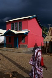 Architecture;-Cloth;-Colours;-Comoros-Archipelago;-Corrugated-roof;-Façade;-France;-House;-Housing;-Indian-Ocean;-Kaleidos;-Kaleidos-images;-La-parole-à-limage;-Laurent-Abad;-Mayotte;-Paved-street;-Red-house;-SIM;-Stories-Pictures;-Stormy-sky;-Street;-Village;-Woman